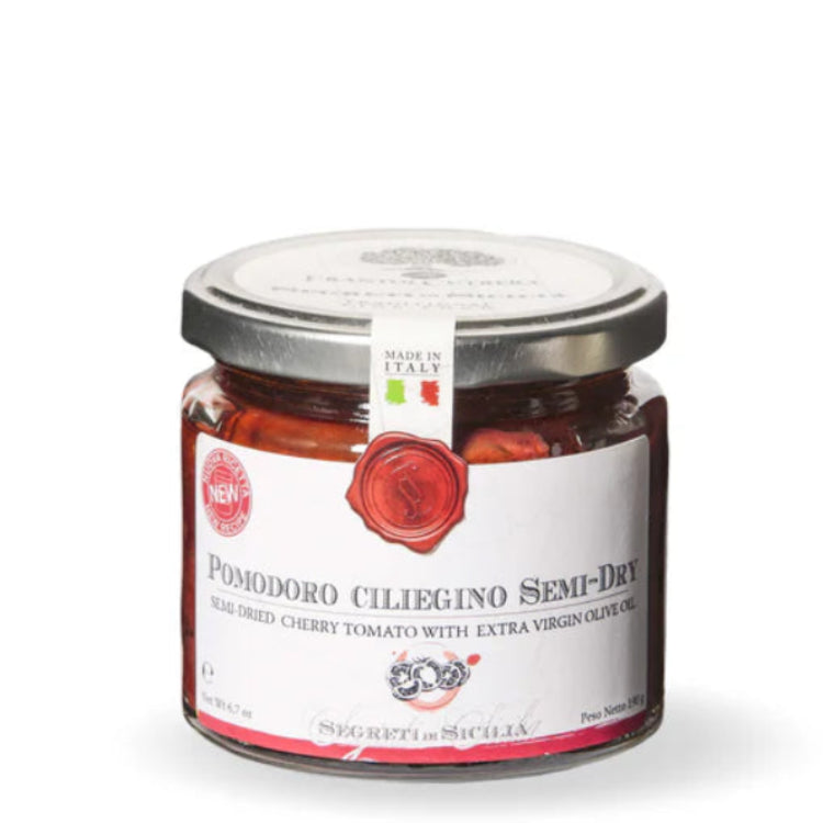 Jar of cherry tomato spread with a label on a white background