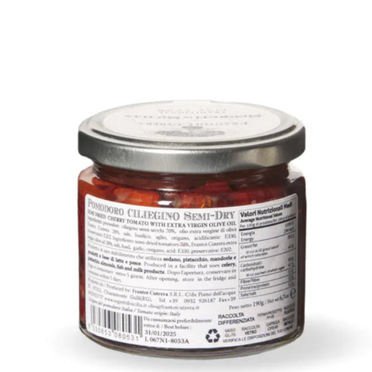 Jar of red spread with a silver lid on a white background
