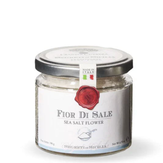 Jar of Fior Di Sale sea salt flowers on a white background
