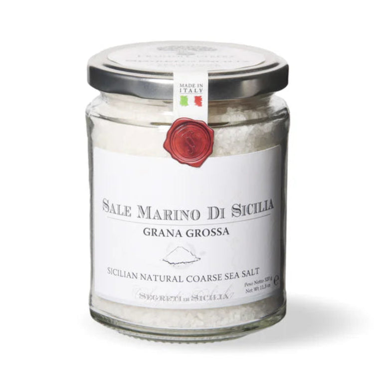 Jar of coarse sea salt with a label on a white background